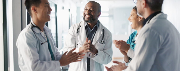 Doctors, nurses and hands together, applause and support, success or collaboration for hospital goals and teamwork. Medical or healthcare people clapping and stack for clinic mission and celebration
