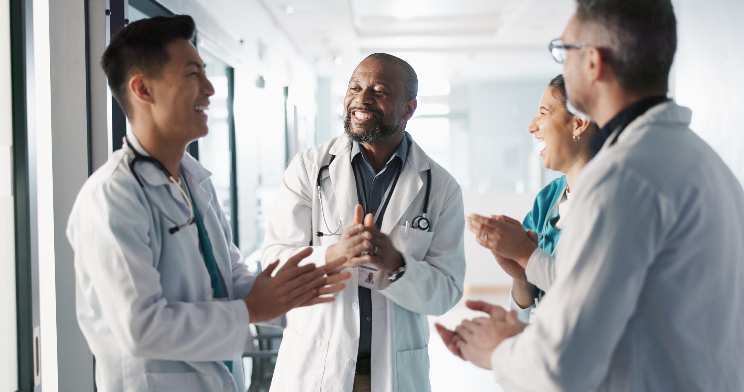 Doctors, nurses and hands together, applause and support, success or collaboration for hospital goals and teamwork. Medical or healthcare people clapping and stack for clinic mission and celebration