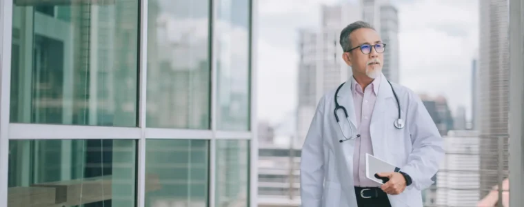 asian chinese male doctor walking towards his office