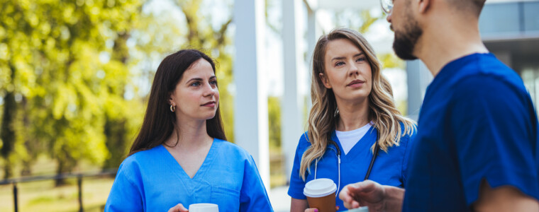Healthcare Professionals Discussing Outdoors During A Coffee Break