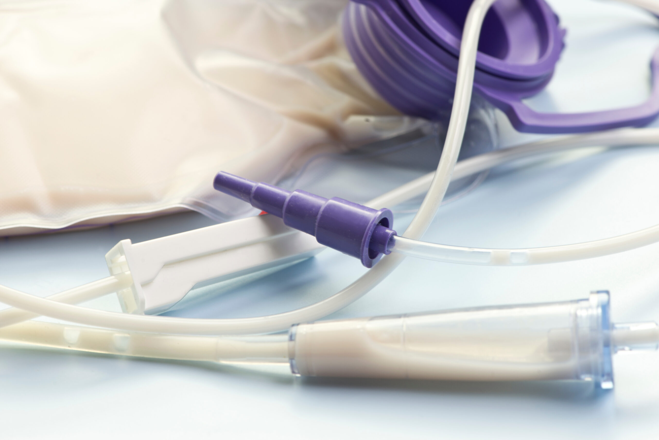 Close-up view of enteral feeding bag with flow adjuster.