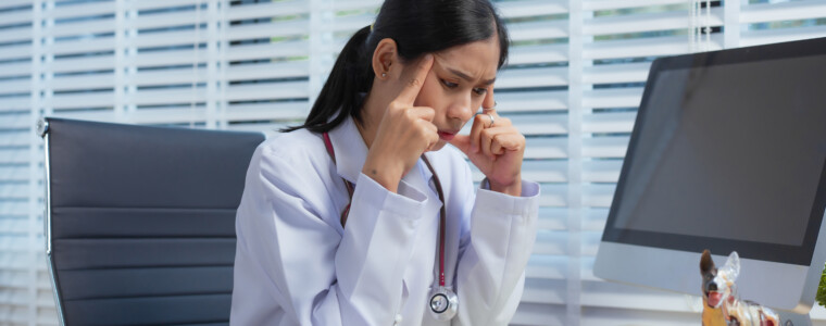 A confident Asian female veterinarian at her animal clinic feels stressed and overwhelmed by office syndrome. Despite dedication, faces moments of sadness and discouragement, struggling with setbacks